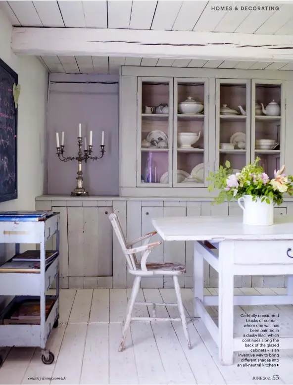  ??  ?? Carefully considered blocks of colour – where one wall has been painted in a dusky lilac, which continues along the back of the glazed cabinets – is an inventive way to bring different shades into an all-neutral kitchen