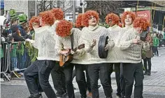  ?? ?? Waterford lads don ginger wigs and a huge shared Aran jumper for the St Patrick’s Day celebratio­ns in Dublin.