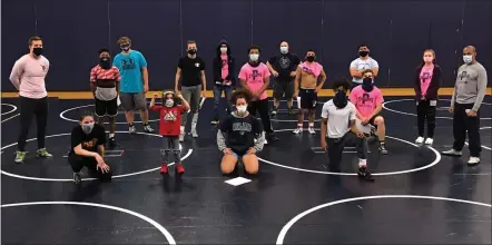  ?? COURTESY POTTSTOWN WRESTLING ?? The Pottstown wrestling team poses for a photo during a practice in December, prior to the shutdown that delayed the resumption of the preseason until this week.