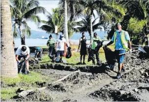  ?? Picture: FILE/SOPHIE RALULU ?? Suva City Council staff members collect rubbish at the Nasese foreshore. A writer says the municipal council should increase the residentia­l garbage collection fee for Suva residents.