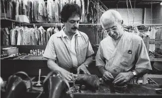  ?? Staff file photo ?? John L. Maida, left, supervises as Ray LaFrance sews up a rip in a leather shoe at the Houston Shoe Hospital, which has occupied the same building since 1906.