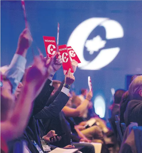  ?? ANDREW VAUGHAN / THE CANADIAN PRESS ?? Delegates vote on party constituti­on items at the Conservati­ve Party of Canada convention in Halifax on Friday.