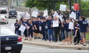  ?? Ernest A. Brown photo ?? Members of the Woonsocket Teachers Guild picket at Market Square Friday evening.