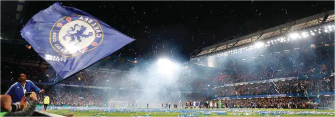  ??  ?? LONDON: Streamers erupt over the pitch at the end of the English Premier League football match between Chelsea and Watford at Stamford Bridge. — AFP