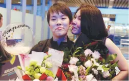  ??  ?? ... National badminton player Goh Jin Wei (left) being greeted by her mother Loh Bee Sim on her return at KL Internatio­nal Airport yesterday after winning the gold medal in the women’s singles badminton event in the Youth Olympic Games in Buenos Aires, Argentina.