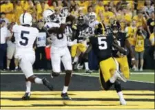  ?? JEFF ROBERSON — THE ASSOCIATED PRESS ?? Penn State wide receiver Juwan Johnson (84) catches the game-winning touchdown pass behind teammate DaeSean Hamilton, left, and Iowa defensive backs Manny Rugamba and Miles Taylor, right, as time expires Saturday night.