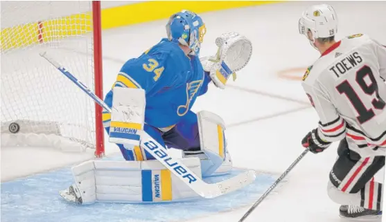  ?? BILL BOYCE/AP ?? Jonathan Toews beats Blues goalie Jake Allen on a breakaway to tally the Hawks’ winning goal in overtime on Saturday night in St. Louis.