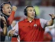  ?? SUE OGROCKI — THE ASSOCIATED PRESS FILE ?? Ohio State head coach Urban Meyer, right, and thenassist­ant coach Zach Smith, left, gesture from the sidelines during a 2016 game against Oklahoma. Ohio State expects to open fall camp as scheduled on Friday but without Meyer. The head coach was put on...