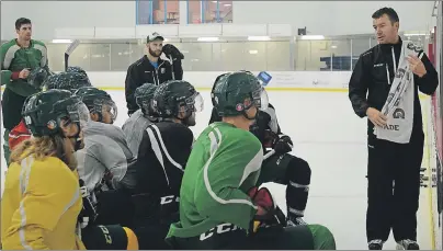  ?? GUARDIAN FILE PHOTO ?? Forbie MacPherson, right, goes over some drills at a practice with the UPEI men’s hockey Panthers. MacPherson has reportedly been signed to a fouryear contract extension.