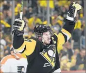  ?? Justin Berl Getty Images ?? SIDNEY CROSBY celebrates after the scoring the first goal of a natural hat trick against the Flyers.