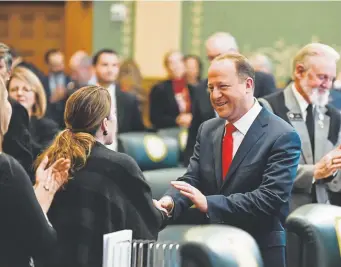  ?? AAron Ontiveroz, The Denver Post ?? Gov. Jared Polis shakes hands with lawmakers after delivering his first State of the State address on Thursday.