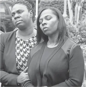  ?? DAVIE HINSHAW, AP ?? Keith Lamont Scott’s widow, Rakeyia, right, and another relative attend a news conference after learning charges would not be filed against officer Brentley Vinson in her husband’s death.