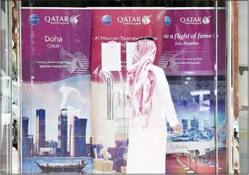  ??  ?? A picture taken on June 5, 2017 shows a man standing outside the Qatar Airways branch in the Saudi capital Riyadh, after it had suspended all flights to Saudi Arabia following a severing of relations between major Gulf states and gas-rich Qatar. Arab...