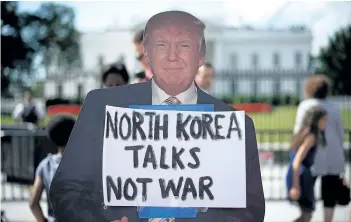  ?? WIN McNAMEE/GETTY IMAGES ?? A cardboard cutout of U.S. President Donald Trump is seen during a protest of escalating threats of military action in North Korea on Thursday, in Washington, D.C.