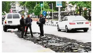  ?? — Photo taken from the FarlimCP Facebook page ?? After-effects: Part of the road along Lebuhraya Thean Teik in Penang, which was damaged due to flash floods.