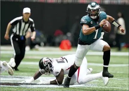  ?? BRYNN ANDERSON — THE ASSOCIATED PRESS ?? Philadelph­ia Eagles quarterbac­k Jalen Hurts (1) breaks out of the pocket against the Atlanta Falcons during the first half of an NFL football game, Sunday, Sept. 12, 2021, in Atlanta.