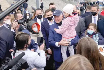  ?? EVAN VUCCI/AP ?? President Joe Biden holds a young girl Saturday while meeting with Ukrainian refugees in Warsaw, Poland.