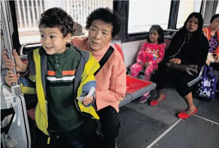  ?? Photos by Mike Kepka / The Chronicle ?? Ben Easter, 4, an avid transit fan since toddlerhoo­d, rides Muni’s K train on an adventure with his grandma, Maria Kwan.