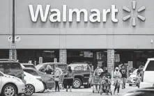  ?? Mark Mulligan / Staff photograph­er ?? Walmart says that it must write the checks to have influence in policies that affect its bottom line — but not Texans’ rights.