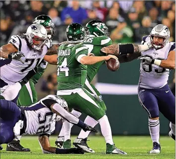 ?? STEVEN RYAN — GETTY IMAGES ?? Danny Shelton, left, and the rest of the Patriots defense rattled the Jets’ Sam Darnold in last week’s shutout. Baker Mayfield and the Browns are up next today.