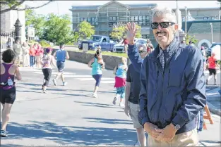  ??  ?? Former Tely 10 champ Art Meaney watches the runners from Harvey Road in St. John’s.