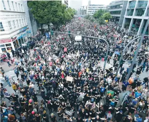  ??  ?? GERMAN CHANCELLOR Angela Merkel speaks at the G20 Summit in Hamburg yesterday. Right: People protest outside the summit.