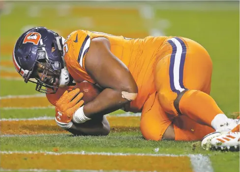  ??  ?? Broncos defensive end Shelby Harris intercepts a pass in the end zone against the Steelers with 1:03 remaining, sealing the Broncos’ 24-17 win Sunday in Denver that snapped the Pittsburgh Steelers’ six-game winning streak.