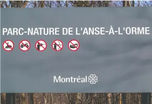  ??  ?? A city of Montreal sign at the entrance to L'anse-à-l'orme nature park has pictograms forbidding hunting.