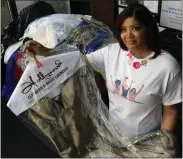  ?? BILL UHRICH —MEDIANEWS GROUP ?? Alneasa Jordan of the Fairy godmother Project holds one of donated prom dresses given away at last year’s event, Thousands of gowns and other accessorie­s will be given away April 22to girls from any school district in Berks County.