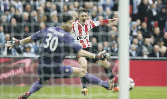  ??  ?? Sunderland’s Italian striker Fabio Borini scores the opening goal past Manchester City’s goalkeeper Costel Pantilimon.