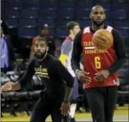  ?? MARCIO JOSE SANCHEZ — THE ASSOCIATED PRESS ?? From left, Cleveland Cavaliers’ Kyrie Irving and LeBron James work on drills during practice Wednesday.