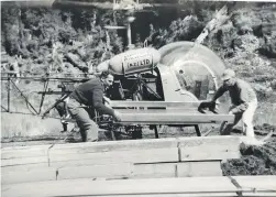  ?? ?? Max White, left, helps unload the prefabrica­ted Wainui Hut in 1958 off the Bell 47 helicopter. Inset left, White, appointed Abel Tasman National Park Ranger in 1951.