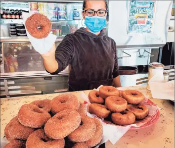  ?? Frank Whitman / For Hearst Connecticu­t Media ?? Picking up the celebrator­y donuts at the Lakeside Diner in Stamford.