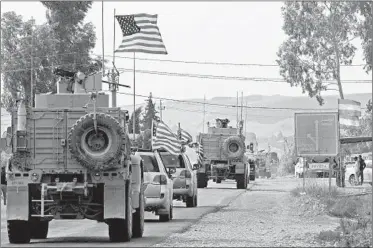  ?? SAFIN HAMED/GETTY-AFP ?? A convoy of US military vehicles arrives Monday near the Iraqi Kurdish town of Bardarash after leaving northern Syria.