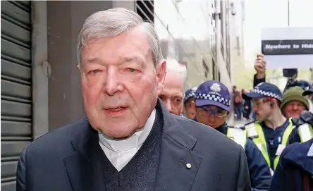  ??  ?? Cardinal George Pell leaves a Melbourne court with a Police escort.