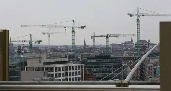  ??  ?? THEY’RE BACK: Cranes as seen from the sixth-floor balcony at the New Central Bank building on Dublin’s North Wall Quay last week are one of a number of possible signs that the recovery really has kept on going, as Enda Kenny has always insisted. Photo:...