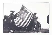  ??  ?? “The large flag at the end of the first day,” 1965, by Dan Budnik.