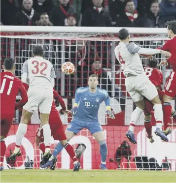  ??  ?? 0 Virgil van Dijk, No 4, heads home Liverpool’s second goal in their 3-1 defeat of Bayern Munich.