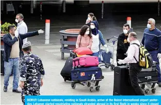  ??  ?? BEIRUT: Lebanese nationals, residing in Saudi Arabia, arrive at the Beirut internatio­nal airport yesterday. Lebanon started repatriati­ng nationals stranded abroad in its first flight in weeks since it closed its internatio­nal airport to stem the novel coronaviru­s. —AFP