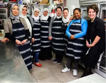  ??  ?? United nations: from left, Pomegranat­e Kitchen’s Nada Jawad, Hajar Mazraeh, Majed Burhan, Muna Al Naser, Fatima Qasim Ali, Nazia Askary, Genet Seyoum and Rebecca Stewart come from six countries.