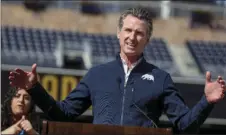  ?? SANDY HUFFAKER/THE SAN DIEGO UNION-TRIBUNE VIA AP, POOL ?? California Governor Gavin Newsom speaks at a news conference at Petco Park, which will host a vaccinatio­n site in a parking lot next to the ballpark in a partnershi­p between San Diego County, the San Diego Padres baseball team, and UC San Diego Health, Monday in San Diego.