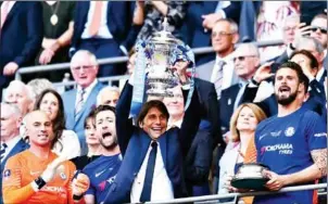  ?? AFP ?? Chelsea head coach Antonio Conte lifts the FA Cup as his players celebrate after beating Manchester United 1-0 in the final at Wembley Stadium on Saturday.