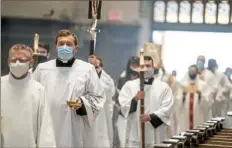  ?? Alexandra Wimley/Post-Gazette ?? Members of the clergy process into St. Paul’s Cathedral for the Diocese of Pittsburgh Chrism Mass on Tuesday in Oakland.