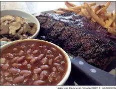  ?? Arkansas Democrat-Gazette/ERIC E. HARRISON ?? Shorty’s Original World-Famous Ribs come in “Shorty’s Size” and “Sadie’s Size” — shown here with sides of fries, baked beans and sauteed mushrooms.