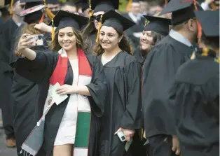  ?? ?? Candidates for bachelors in science Elysia Escobedo, from left, Aleydis Maldonado, and Jennifer Burgos take a selfie together before the Purdue University Northwest commenceme­nt ceremony.