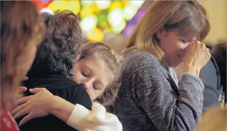  ?? Genaro Molina Los Angeles Times ?? GABRIELLA GATHMAN hugs her grandmothe­r; at right is her mother, Teresa Gathman. The family had 20 minutes to evacuate.