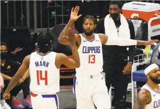  ?? Christian Petersen / Getty Images ?? The Clippers’ Paul George (13) celebrates with Terance Mann during L.A.’s Game 5 victory over Phoenix. George scored 41 points as the Clippers pushed the series to a sixth game.