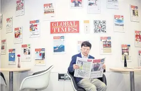  ??  ?? Editor-in-chief Hu Xijin reads the Global Times at the nationalis­t tabloid’s offices in Beijing.