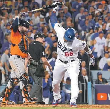  ?? Wally Skalij Los Angeles Times ?? YASIEL PUIG of the Dodgers is frustrated after flying out to center field in the third inning with two runners on base as Houston Astros catcher Brian McCann and umpire Mark Wegner watch the play.