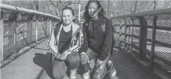  ??  ?? Best friends Sammy Siscoe and Tiana Benoit, both 12, meet on the bridge every weekday morning and walk to Fisher Park school together. It gives them a chance to chat before the school day begins.